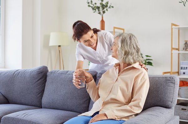 assisted-living-caregiver-helping-elderly-woman-home